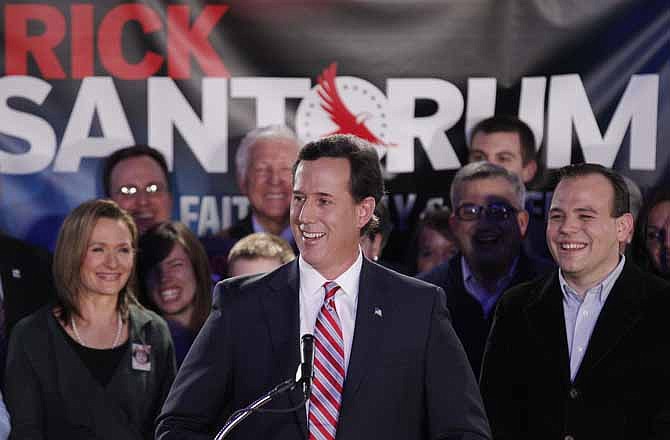 Republican presidential candidate, former Pennsylvania Sen. Rick Santorum, joined by wife Karen, left, addresses supporters at his Iowa caucus victory party Tuesday, Jan. 3, 2012, in Johnston, Iowa.