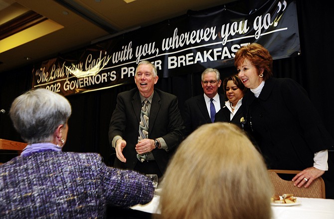 Pastor Randy Gariss, of Joplin's College Heights Christian Church, center left, and his wife, Julie Gariss, right, greet well-wishers following the Governor's Prayer Breakfast at the Capitol Plaza Hotel.