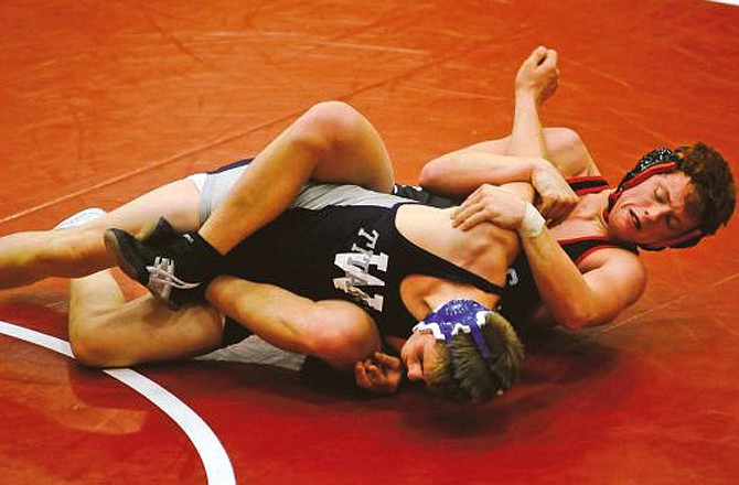 Zach Eggen of Jefferson City tries to move David Padget of Lee's Summit West to his back during their 182-pound match Saturday in the GFI Duals at Fleming Fieldhouse.