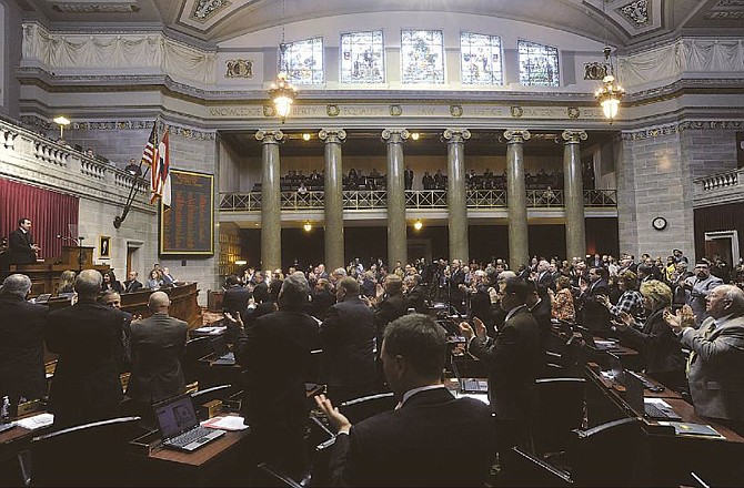 Members of the Missouri House of Representatives give House Speaker Steve Tilley, R-Perryville, left, a standing ovation following his opening day remarks.