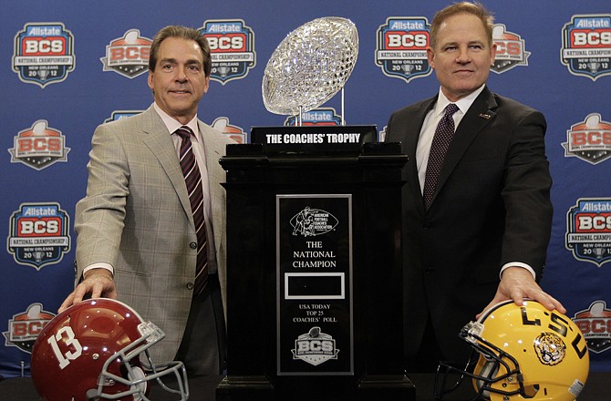 Alabama head coach Nick Saban (left) and LSU head coach Les Miles pose for a picture Sunday with the BCS Championship trophy in New Orleans.