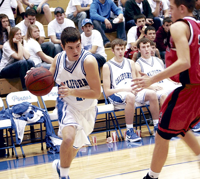 California's Cole George drives around an Eagle during the JV game Friday at California High School. The JV Pintos defeated Southern Boone 50-45.