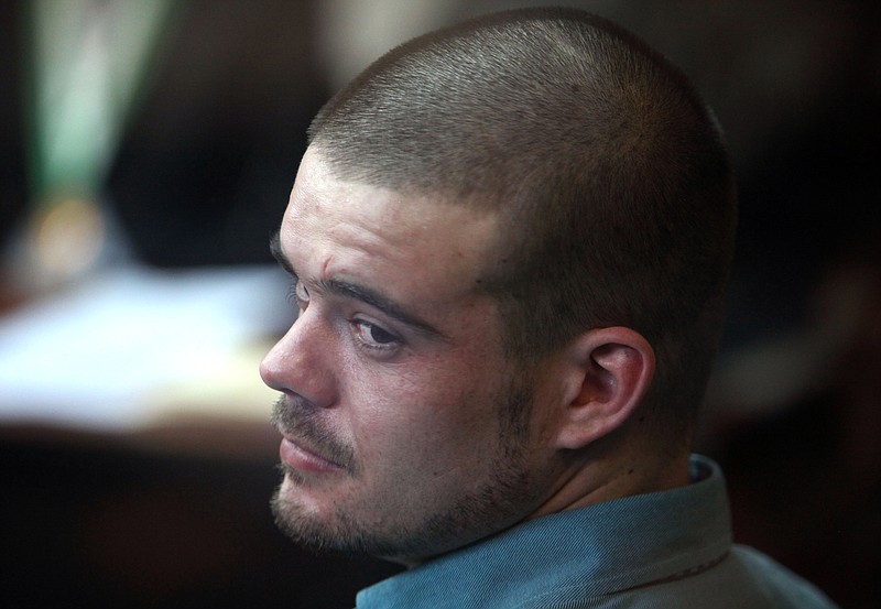 Joran van der Sloot looks back from his seat after entering the courtroom Wednesday for the continuation of his murder trial at San Pedro prison in Lima, Peru.