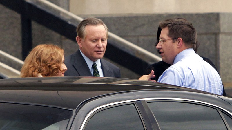 Former Republican Rep. Mark Deli Siljander, center, his wife Nancy, left, and members of his legal team leave federal court in Kansas City. Siljander, accused of accepting stolen funds on behalf of a Missouri charity with alleged terrorism ties, is among five men being sentenced in the case Wednesday in federal court in Kansas City.