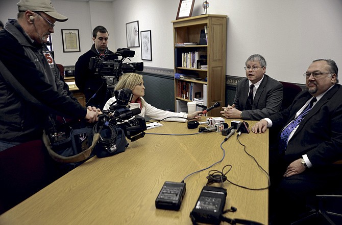 Public defenders Charlie Moreland, left, and Donald Catlett, right talk with reporters Tuesday after their client Alyssa Bustamante entered a guilty plea to second-degree murder in the 2009 death of 9-year-old Elizabeth Olten.