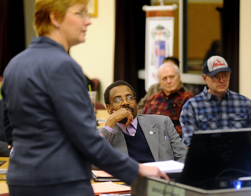 W.T. Edmonson, center, president of Jefferson City Congregations United, listens as Anne Schneider of First Presbyterian Church gives a presentation about predatory lending in Missouri during an Interfaith Call To Action: Fair Lending for Mid-Missouri Families event at the Catholic Pastoral Center on Thursday.