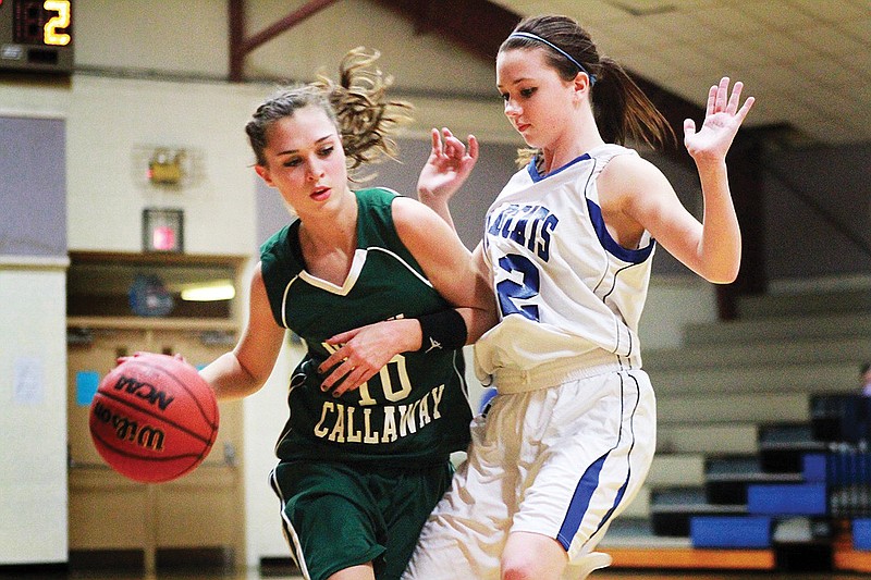 North Callaway senior guard Jordan Gray tries to dribble past a Montgomery County defender during the Ladybirds' 50-33 victory Wednesday night in the consolation semifinals of the South Callaway Tournament at Mokane.