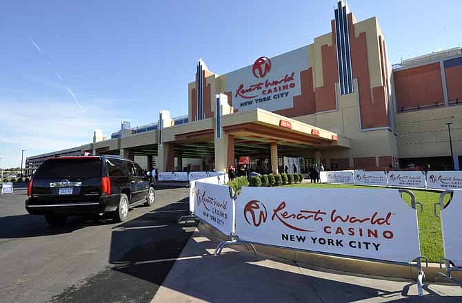 This Oct. 28, 2011 file photo shows the front entrance of the Resorts World Casino on the day of its official opening as New York City's first casino at the Aqueduct Racetrack, in Jamaica in the Queens borough of New York. A Malaysian company's plan to build a $4 billion convention center and big-time casino at Aqueduct could be the biggest shot fired yet in a tourism arms race that has seen a growing number of Eastern states embrace gambling as a way to lure visitors and drum up revenue.