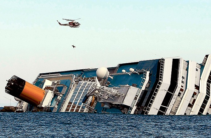 An Italian firefighter helicopter lifts a rescued passenger Sunday from the luxury cruise ship Costa Concordia, which ran aground off the tiny Tuscan island of Giglio, Italy.