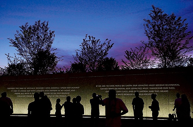 Quotes by Martin Luther King Jr. are inscribed in the wall at the Martin Luther King Jr. Memorial as it is seen at dusk ahead of its dedication.