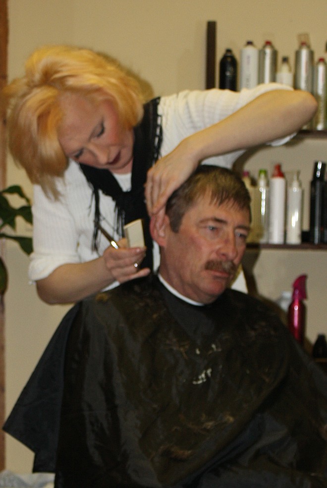 Krys Cobs of COBS Hair Salon in the Petro Truck Stop Shopping Center in Kingdom City cuts the hair Monday of Ernest Bell of Toledo.