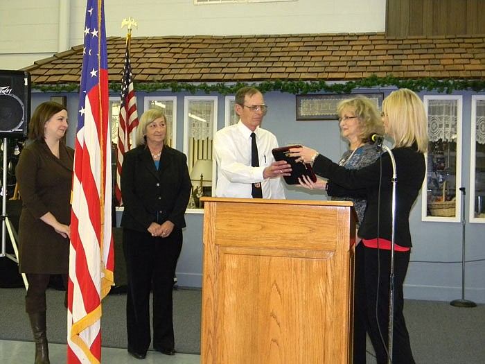 Family members present as Bonnie George and Sally Vogel present George Shelley with the 2010 Citizen of the Year Award at the 2011 California Area Chamber of Commerce Annual Dinner; from left, are Tracy King, Kathryn Shelley, George Shelley, Vogel and George. Who will be revealed as the 2011 Citizen and Business of the Year at this year's Annual Dinner to be held Saturday, Jan. 28, at the California Nutrition Center.