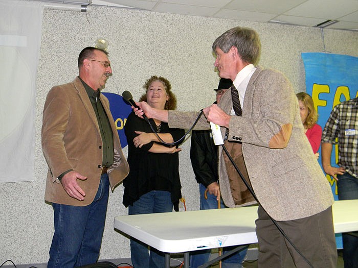 Kirby "Richard Dawson" Baumert asks a question to Rick Herndon of the Herndon Family at the "Family Feud" event held Saturday, Jan. 14, at the Jamestown Community Building, from left, are Regan Russell, Emily Scheperle, Marcy Oerly and Natalie Bish.