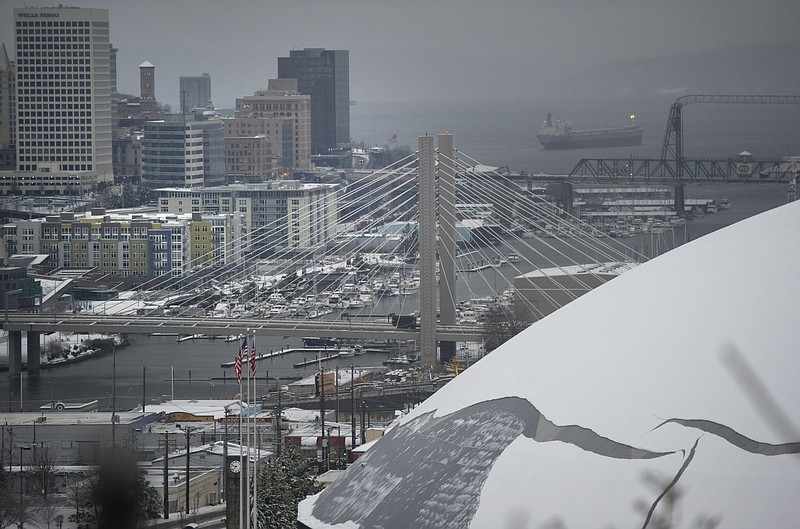 Snow covers the The Tacoma Dome on Thursday in Tacoma, Wash. An ice storm followed heavy snow in western Washington, bringing down trees that killed one person and knocked out power for about 100,000 homes while sending cars and trucks spinning out of control.