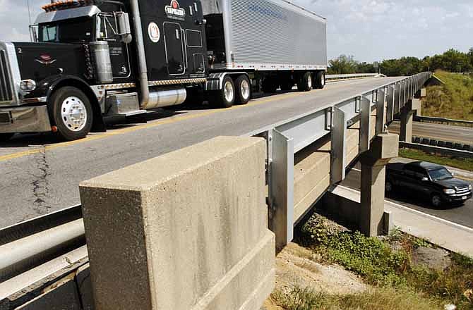 In this Aug. 28, 2007 file photo, a truck drives on the Highway 40 bridge over I-70 near Midway, Mo. 
