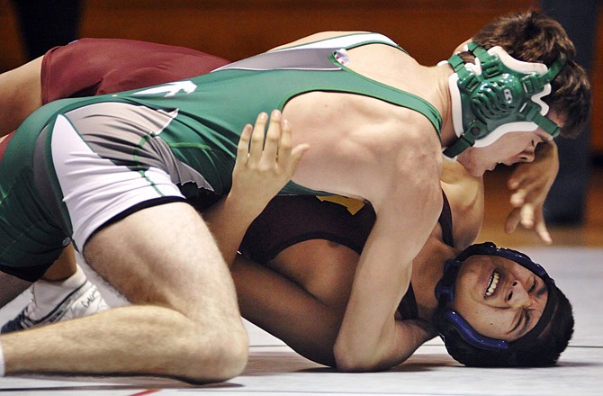 Brad Thomas of Blair Oaks works Brandon Doggett of Missouri Military Academy onto his back during their 145-pound match Thursday night in Wardsville.