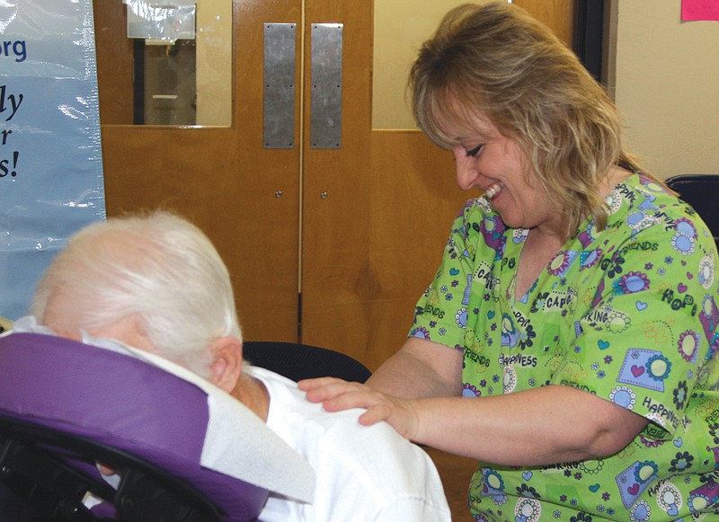 Deirdre Huenneke, licensed massage therapist, gives Larry Leopold, of Auxvasse, a free massage Thursday at the Fulton Medical Clinic's booth during the Senior "Living the Dream" Expo.