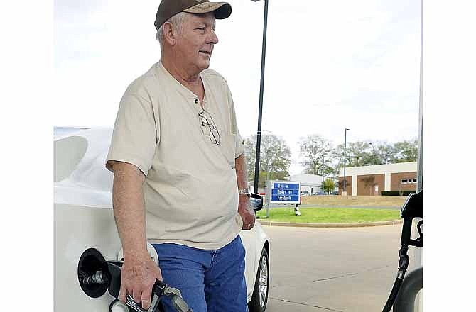Jim Jackson of Stephenville, Texas, fills up Tuesday, Jan. 17, 2012, at a Rudy's Exxon station in Nacogdochoes, Texas. Jackson, who is partners in an oil production company in Stephenville, said increasing fuel prices haven't impacted his driving habits but his lifestyle and spending have changed as he tries to save more for an uncertain economic future. (AP Photo/The Daily Sentinel, Andrew D. Brosig)
