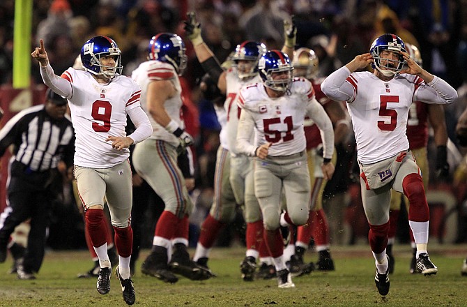 New York Giants kicker Lawrence Tynes (9) and punter Steve Weatherford (5) celebrate after Tynes kicked the game winning field goal during overtime of the NFC Championship game in San Francisco. The Giants won 20-17 to advance to Super Bowl XLVI.