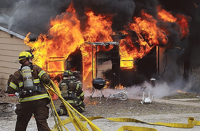 A Franklin County firefighter battles a blaze from a shake-and-bake meth lab explosion at a house in Union. The crude method of making meth in a 2-liter soda bottle is filling hospitals with thousands of uninsured burn patients.