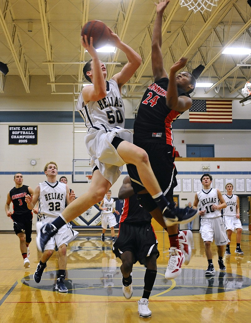 Hale Hentges of Helias goes up against Hannibal's Mike Shivers during Tuesday night's game at Rackers Fieldhouse.