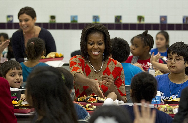 First lady Michelle Obama has lunch with school children Wednesday at Parklawn Elementary School in Alexandria, Va. Celebrity cook Rachael Ray, left, also ate with the students after new school lunch guidelines were announced.