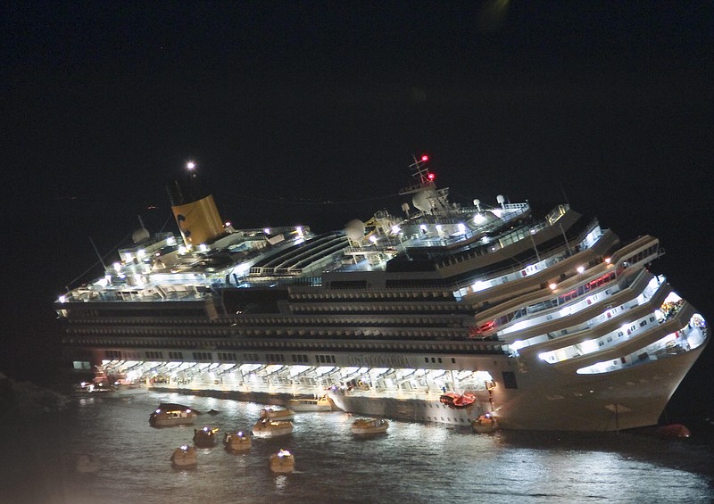 The luxury cruise ship Costa Concordia lays on its starboard side Jan. 13 after it ran aground off the coast of the Isola del Giglio island, Italy. Representatives of the ship operator met with consumer activists Thursday to discuss compensation for passengers who suffered no physical harm.