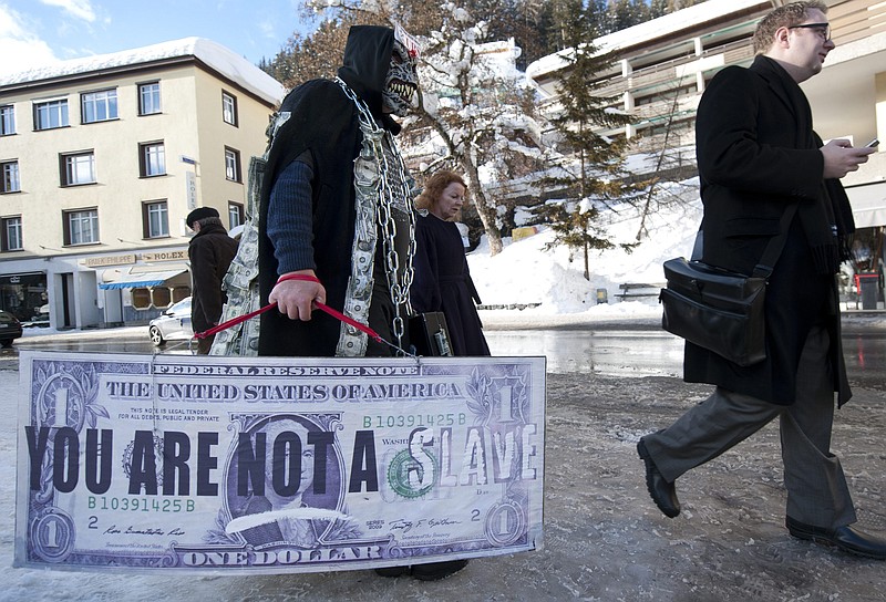 A demonstrator stages a protest in the street Thursday during the 42nd annual meeting of the World Economic Forum in Davos, Switzerland.