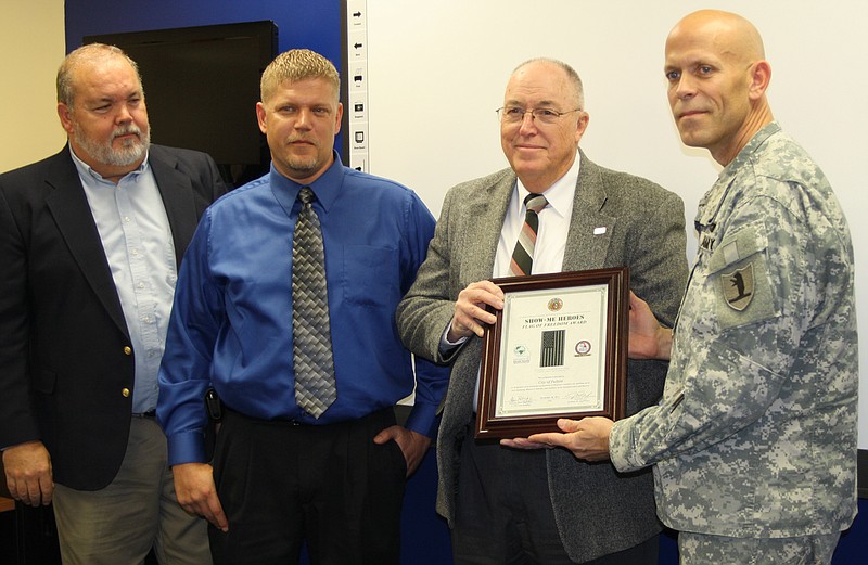 Fulton Mayor LeRoy Benton, second from right, receives a Missouri Show-Me Heroes award Thursday for the City of Fulton hiring two veterans last year. From left are Jerry Brown, Missouri Career Center in Mexico, Mo., Jeremy Prince, one of the veterans hired by the City of Fulton, and Lt. Col. Alan Rohlfing, director of Show-Me Heroes. 