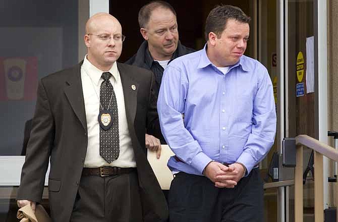In this Wednesday, Jan. 25, 2012 photo, Matthew J. Nelson, 33, right, a Grain Valley teacher and coach, is led out of the Grain Valley Police Department in Grain Valley, Mo. Prosecutors charged Nelson, a suburban Kansas City elementary school teacher with molesting four young boys, and police have called on the parents of other students he has taught or coached to come forward if they also suspect abuse. (AP Photo/The Kansas City Star, David Eulitt)