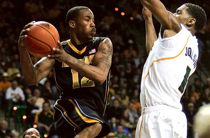 Marcus Denmon of Missouri looks to pass around the defense of Baylor's Perry Jones III during a game earlier this month in Waco, Texas.