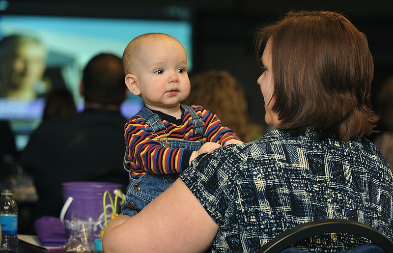 Quincy Gilliland looks around the room as his mom, Jamie Gilliland, watches a video presentation. Both were in attendance at Tuesday's March of Dimes Fundraising Kickoff. Teams gathered to pick up informational kits, hear speakers and to share ideas on raising money. Gilliland is a labor nurse at St. Mary's Health Center and has been involved with the hospital's team, which has been a team for more than 20 years. 