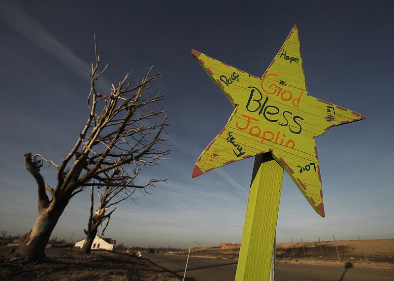 An inspirational sign sits Jan. 18, 2012 at an intersection in a neighborhood destroyed nearly eight months ago by an EF-5 tornado that tore through Joplin.