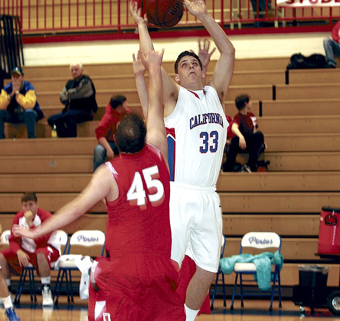 Alec Ramsdell (33) rebounds his own shot then puts it back up to score two points for California during the first quarter of the varsity game against Dixon Saturday. The Pintos  defeated the Bulldogs 75-69. California's JV also won, 69-26.