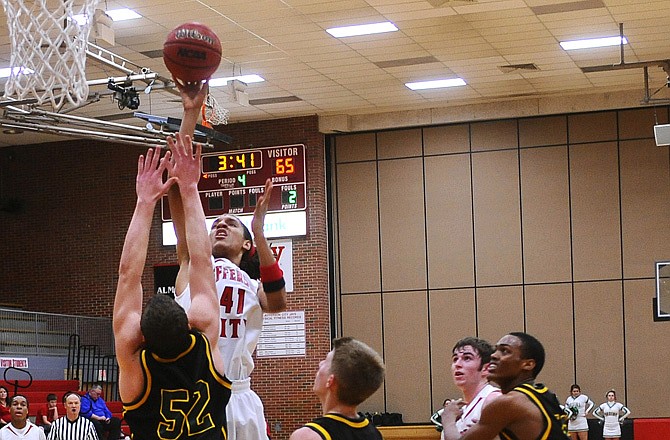 Jefferson City's Chauncey Harris puts up a shot over Rock Bridge's Austin Ray during Tuesday's game at Fleming Fieldhouse.