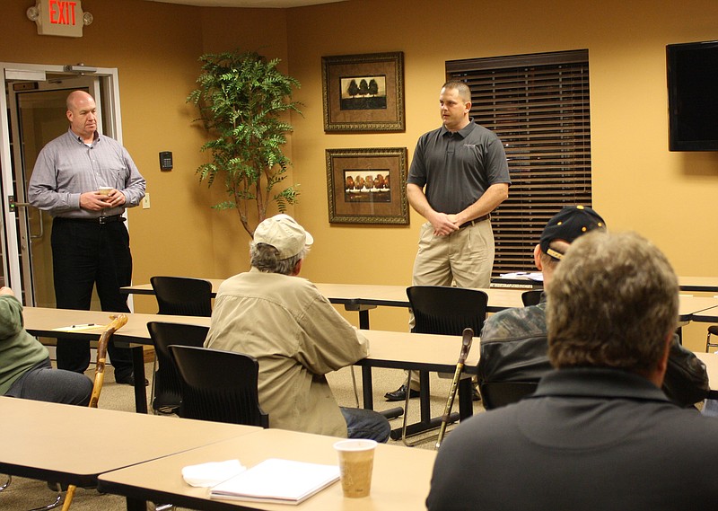 Two representatives of Propane Education and Research Council, Marc Porth and Tom Proctor, from left standing, discuss conversion of gasoline engines to propane during a Holts Summit Community Betterment Association meeting Tuesday night in Holts Summit.