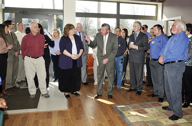 Phil Freeman (pointing) was one of several dozen in attendance to Thursday's ribbon cutting ceremony and open house at the Old Town Center on Clark Avenue at Atchison Street.