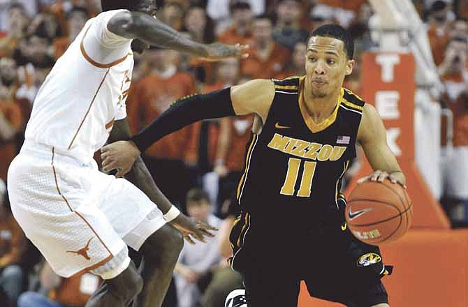 Missouri's Michael Dixon drives around Texas' Myck Kabongo during the first half of the Tigers' win over the Longhorns on Monday night in Austin, Texas. 
