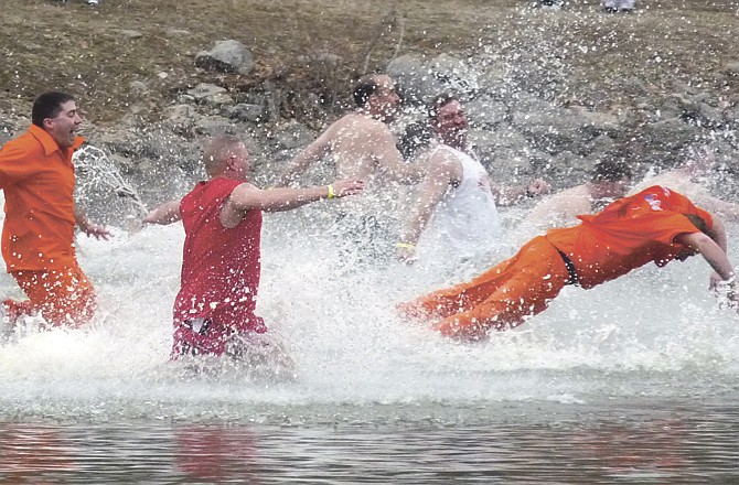 In this file photo from 2011, members of the "Davis Dogs" and Jefferson City Department of Corrections group plunge and dive into the waters during the annual event. 
