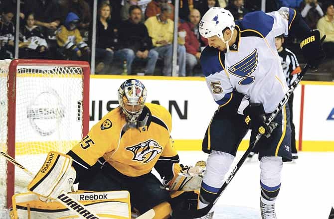 Nashville Predators goalie Pekka Rinne (35), of Finland, stops a shot by St. Louis Blues right wing Chris Stewart (25) in the first period of an NHL hockey game on Saturday, Feb. 4, 2012, in Nashville, Tenn.