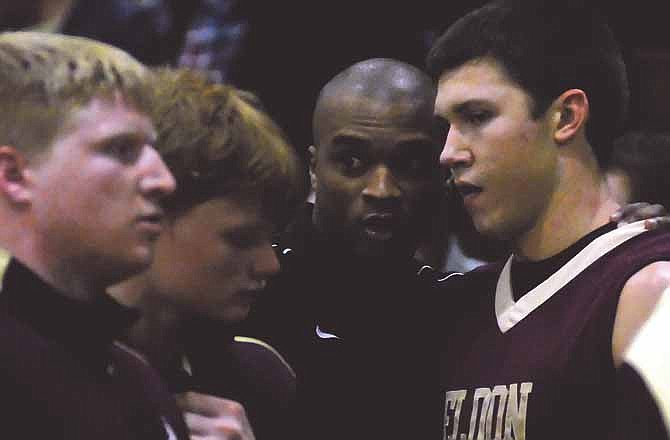 Assistant Eldon Mustang Coach and former Helias basketball standout Jamaal Tatum (center) talks with Eldon players Friday just before they took on Helias in boys basketball at Rackers Fieldhouse in Jefferson City.