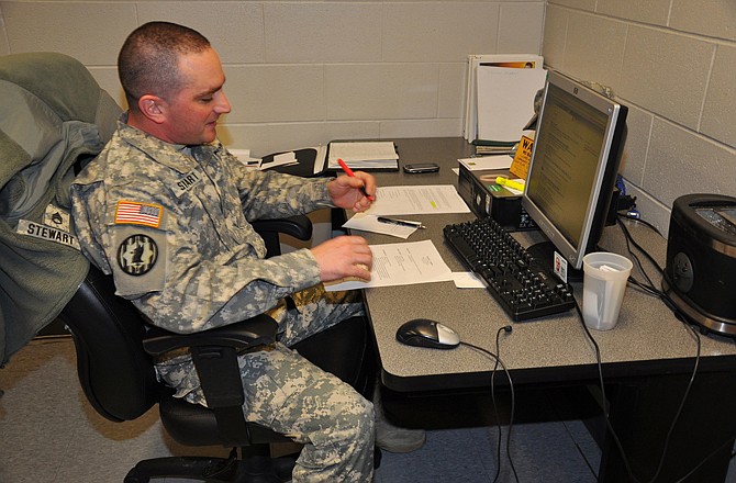 Staff Sgt. Jared Stewart, an employee assistance noncommissioned officer, edits a military member's resume. Stewart helps service members and spouses find jobs and also helps them with writing resumes, preparing for interviews, and job placement.
