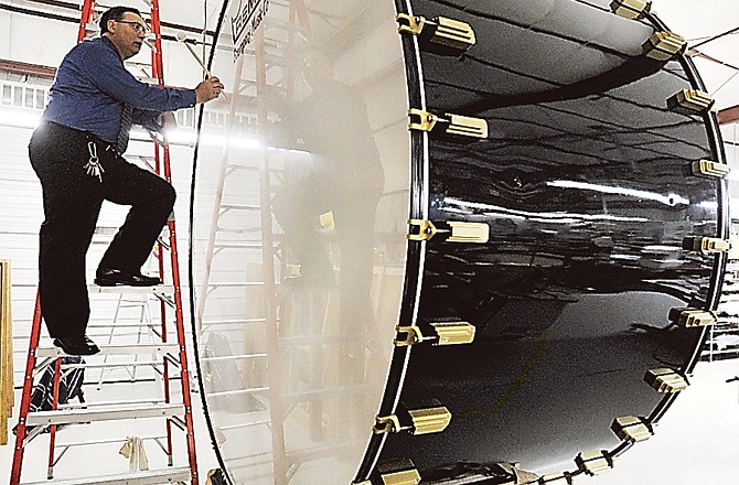 Gordon College music instructor Neil Boumpani tunes "Big Mo," the name given to what he calls the largest bass drum ever manufactured in the United States. Built by Boumpani, at 9 feet in diameter, the instrument is an 800-pound gorilla that will soon take the field with the Tigers and Marching Mizzou at the University of Missouri in Columbia.