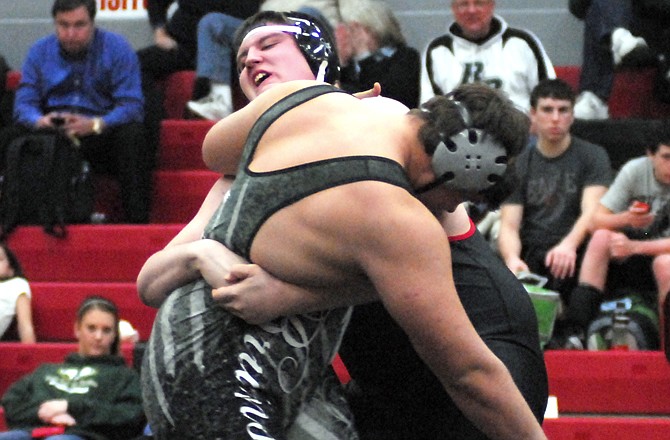 John Carter of Jefferson City gets a grip on Michael Stennard of Rock Bridge during their 285-pound match Monday night at Fleming Fieldhouse.