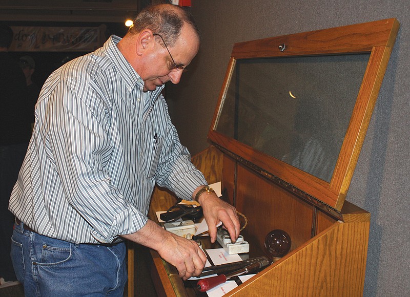 Jim Winemiller, business representative for the International Brotherhood of Electrical Workers Local 257, sets up a display of tools Monday the union has loaned to the National Churchill Museum for The Way We Worked exhibit.
