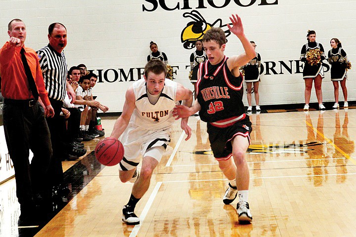 Fulton senior guard Austin Moore tries to drive past Kirksville's Tyson Grgurich along the sideline during the Hornets' 54-51 NCMC loss to the Tigers on Tuesday night at Roger D. Davis Gymnasium.