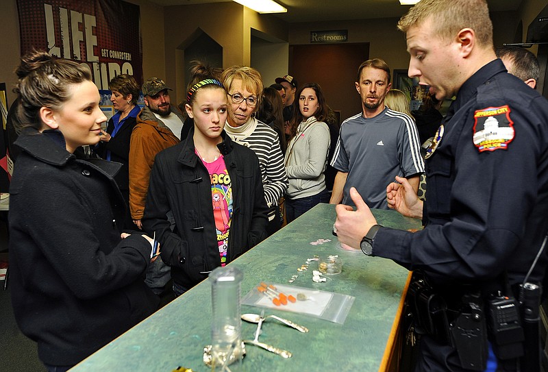 Jefferson City Police Officer Collier Nichols describes the various forms and ingestion methods of heroin to a gathered crowd during a heroin awareness community town hall meeting at First Assembly of God Church on Thursday night.