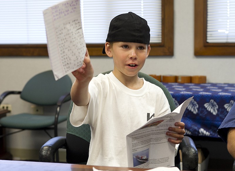 Nine-year-old West James on Thursday shows off the diary he kept while sailing across the Pacific. James, his father and uncle were attempting their first voyage across the Pacific in a sailboat when rough seas damaged their boat hundreds of miles from land.