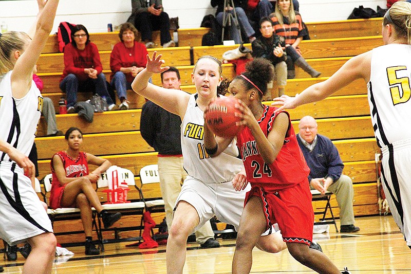 Fulton junior forward Bailey Mitchell defends against Hannibal sophomore forward Lauren Holliday during the Lady Hornets' 55-50 NCMC win over the Lady Pirates on Thursday night at Roger D. Davis Gymnasium.