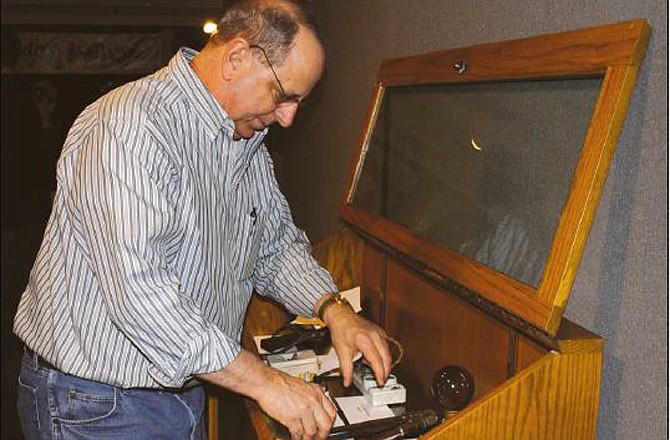 Jim Winemiller, business representative for the International Brotherhood of Electrical Workers Local 257, sets up a display of tools Monday the union has loaned to the National Churchill Museum in Fulton, Mo., for The Way We Worked exhibit. 